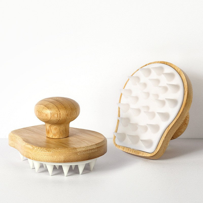 1:1 close-up of the actual silicone scalp brush with its handle and flexible bristles visible.
